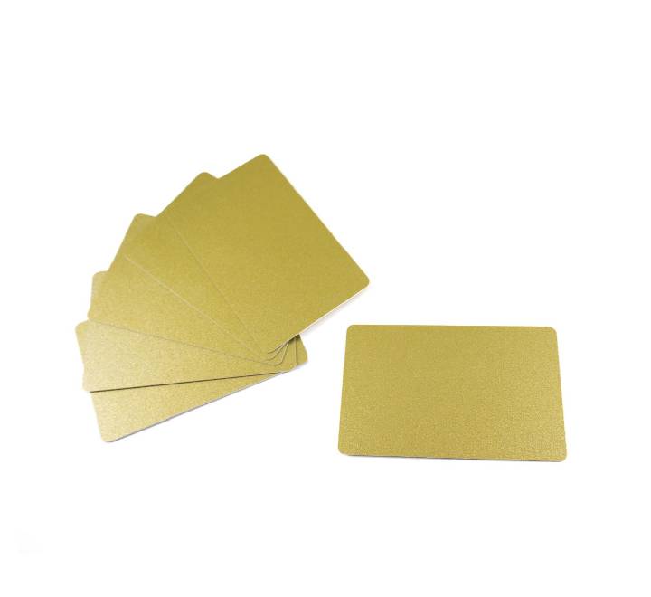 Close-up of CR80 standard 30-mil thickness metallic gold plastic card surface