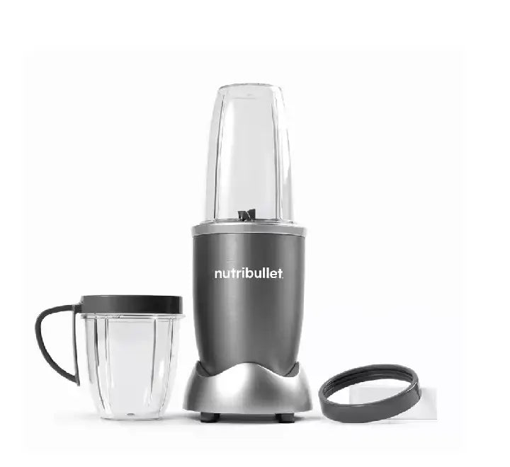 Hand twisting tall cup onto NutriBullet 600W motor base to start blending