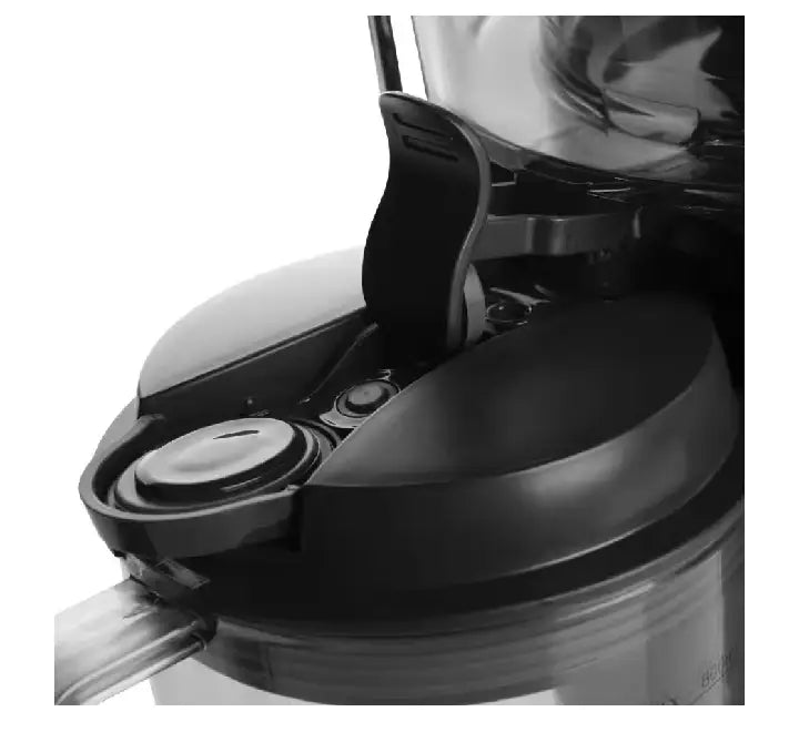 Whole apples being inserted into the 3-inch wide feed chute of the NutriBullet Juicer