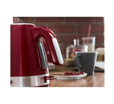 De'Longhi KBLA 2000.R kettle being lifted from its cordless 360 degree swivel base, showcasing the removable anti-scale mesh filter.