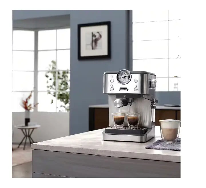 The 360-degree adjustable stainless steel manual cappuccino steam wand texturing milk foam in a pitcher.