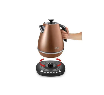 Premium De'Longhi Distinta style copper electric kettle sitting on a modern kitchen countertop lifestyle setting.