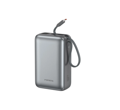 Foneng PX128 65W power bank connected to a modern USB-C laptop on a workspace desk.