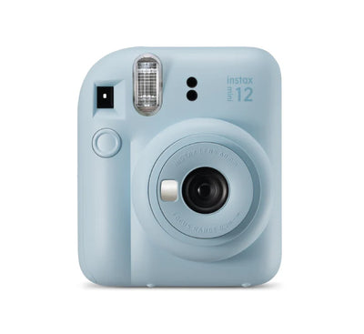 A hand holding a freshly printed instax mini photo showing the vibrant colors and 90-second development time.
