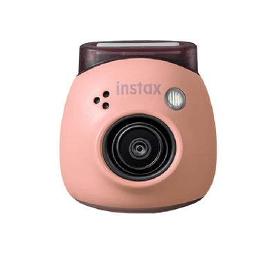 Ultra-compact instax Pal digital camera held in the palm of a hand to demonstrate its tiny size.
