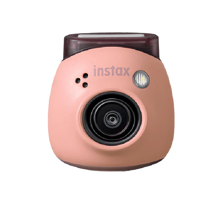 Ultra-compact instax Pal digital camera held in the palm of a hand to demonstrate its tiny size.