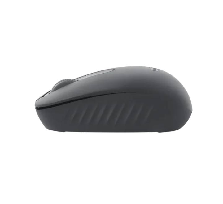 Logitech M196 compact Bluetooth mouse positioned neatly next to a slim ultrabook in a modern remote work setting.