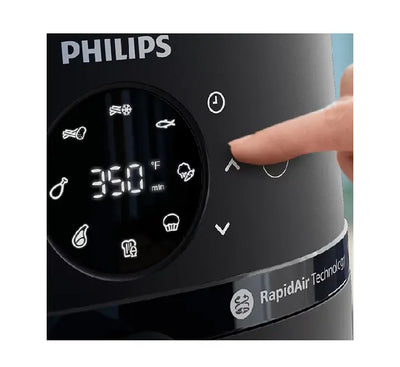 Close-up of Philips NA220 Airfryer featuring transparent viewing window and sleek silver basket handle