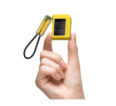 Yellow Sharge Disk M.2 NVMe SSD enclosure plugged into a smartphone, demonstrating compact external storage use.