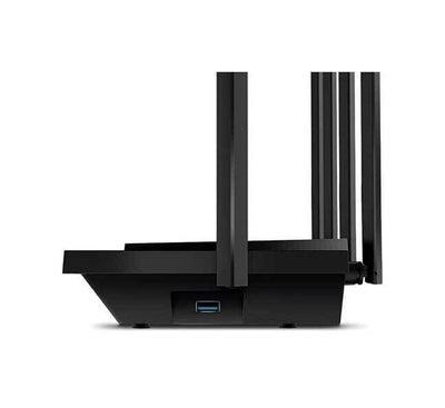 The TP-Link Archer AX72 Wi-Fi 6 router set up neatly on a living room shelf, delivering high-speed internet coverage for smart home entertainment setups.